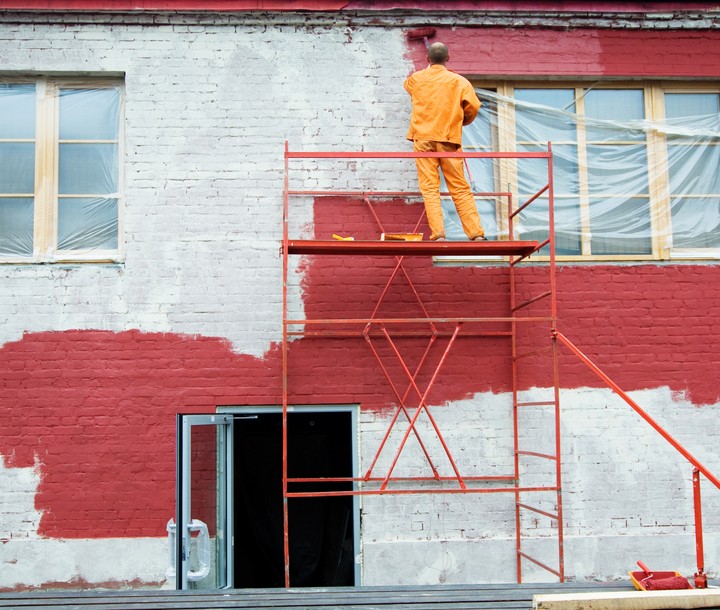 a man painting an exterior wall