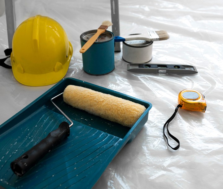 helmet, paint brush and other items laying on the ground